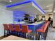 Bar area with comfortable chairs and a bartender serving guests at 125 Prima Dr, Poinciana, FL 34759