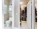 Well-organized bathroom with a toilet, vanity, and an open closet, maximizing space and functionality at 125 Prima Dr, Poinciana, FL 34759