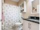 Well-lit bathroom with a shower-tub combination, vanity, and storage, ideal for a comfortable and functional space at 125 Prima Dr, Poinciana, FL 34759
