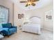 This bright bedroom features tile floors, a comfortable armchair, and a relaxing window view at 125 Prima Dr, Poinciana, FL 34759