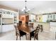 Open-concept dining room with tile flooring and access to kitchen and living areas at 125 Prima Dr, Poinciana, FL 34759