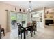 Dining area featuring a chandelier, dark wood table, and sliding glass doors at 125 Prima Dr, Poinciana, FL 34759