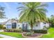 Charming single-story home with a well-manicured lawn, lush landscaping, and inviting curb appeal at 125 Prima Dr, Poinciana, FL 34759