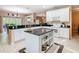 Spacious kitchen with white cabinetry, granite countertops, and a center island at 125 Prima Dr, Poinciana, FL 34759