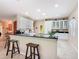 Spacious kitchen with breakfast bar, white cabinetry, and stainless steel appliances at 125 Prima Dr, Poinciana, FL 34759