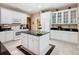 Bright kitchen featuring white cabinets, granite countertops, and a center island at 125 Prima Dr, Poinciana, FL 34759