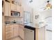 This kitchenette boasts stainless steel appliances, marble countertops, and built-in cabinetry for storage at 125 Prima Dr, Poinciana, FL 34759