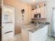 This cozy kitchenette features marble countertops, stainless steel appliances, and access to the bathroom at 125 Prima Dr, Poinciana, FL 34759