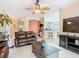 Inviting living room with tile floors, ceiling fan, and open floor plan at 125 Prima Dr, Poinciana, FL 34759