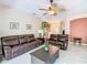 Cozy living room featuring comfortable seating, tile floors, and a ceiling fan at 125 Prima Dr, Poinciana, FL 34759