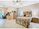 Spacious main bedroom with neutral tones, tile flooring, and an attached desk area for work or study at 125 Prima Dr, Poinciana, FL 34759