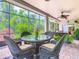 Charming patio featuring a wicker table set perfect for outdoor dining with lush greenery in the background at 125 Prima Dr, Poinciana, FL 34759