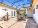 Charming outdoor patio with brick flooring, perfect for entertaining with a tranquil fountain, and well-manicured surroundings at 125 Prima Dr, Poinciana, FL 34759