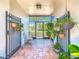 Charming covered porch with wrought-iron details and hanging plants at 125 Prima Dr, Poinciana, FL 34759