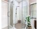 Modern walk-in shower featuring marble tiling, a glass enclosure, and a sleek design for a luxurious bathing experience at 125 Prima Dr, Poinciana, FL 34759