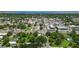 Wide aerial view highlighting the city near a charming gray home and lake at 1322 New York Ave, St Cloud, FL 34769