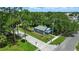 Overhead shot of a charming gray home featuring a fenced yard and blue porch roof at 1322 New York Ave, St Cloud, FL 34769