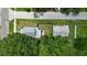 Aerial view capturing the house with a spacious backyard, a shed, mature trees, and street access at 1322 New York Ave, St Cloud, FL 34769