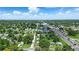 A tranquil aerial view of a quaint town, featuring lush greenery and a prominent water tower at 1322 New York Ave, St Cloud, FL 34769