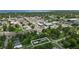 A birds eye view of a home near the downtown area and the ocean, surrounded by lush greenery at 1322 New York Ave, St Cloud, FL 34769