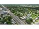 Aerial view of a neighborhood along a main road featuring the St. Cloud water tower and lush tree coverage at 1322 New York Ave, St Cloud, FL 34769
