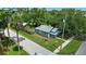 Aerial view of a charming gray home with a fenced yard and a blue porch roof at 1322 New York Ave, St Cloud, FL 34769