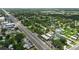 Aerial view of a neighborhood along a main road featuring the St. Cloud water tower and lush tree coverage at 1322 New York Ave, St Cloud, FL 34769
