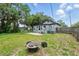 Spacious backyard with a fire pit, basketball hoop, and a fenced perimeter at 1322 New York Ave, St Cloud, FL 34769