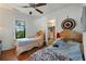 Bright bedroom with wood floors, two beds, and an open closet at 1322 New York Ave, St Cloud, FL 34769