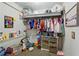 Cozy closet featuring ample hanging space, shelving, and colorful decor for clothing and accessories at 1322 New York Ave, St Cloud, FL 34769