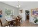 Dining room with wood floors, decorative table, and a view to the backyard at 1322 New York Ave, St Cloud, FL 34769