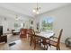Open floorplan with dining area with stylish table and view into the living room at 1322 New York Ave, St Cloud, FL 34769