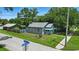 A charming gray home with a fenced yard and blue porch roof at 1322 New York Ave, St Cloud, FL 34769
