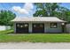 Exterior view of the detached garage with two bays, offering convenient parking and extra storage space at 1322 New York Ave, St Cloud, FL 34769