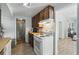 Kitchen featuring wood-grain cabinets and countertops and white appliances plus view to the bathroom at 1322 New York Ave, St Cloud, FL 34769
