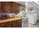 Bright kitchen featuring wood-grain cabinets and countertops and white appliances at 1322 New York Ave, St Cloud, FL 34769