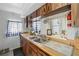 Kitchen featuring wood-grain cabinets and countertops, double sinks and a window at 1322 New York Ave, St Cloud, FL 34769