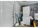 Laundry area featuring a stacked washer and dryer set and cleaning supplies at 1322 New York Ave, St Cloud, FL 34769