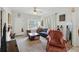 Cozy living room featuring carpet, natural light from a window, and comfortable furnishings at 1322 New York Ave, St Cloud, FL 34769