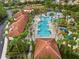 Aerial view of community pool and splash pad with palm trees, lounge chairs and water park at 1416 Oak Marsh St, Davenport, FL 33837