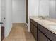 Bright bathroom features double vanity with modern fixtures and neutral-toned tile flooring at 1416 Oak Marsh St, Davenport, FL 33837