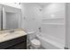 This bathroom offers a tub and shower combination, a single sink vanity and neutral paint tones at 1416 Oak Marsh St, Davenport, FL 33837