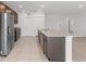 Modern kitchen with stainless steel appliances and a large island at 1416 Oak Marsh St, Davenport, FL 33837