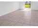 The living room has neutral paint and tile flooring and plenty of natural light from the sliding door at 1416 Oak Marsh St, Davenport, FL 33837