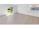 The living room has neutral paint and tile flooring and plenty of natural light from the sliding door at 1416 Oak Marsh St, Davenport, FL 33837