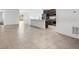 Bright, open-concept space with tile flooring leading to kitchen with island and stainless steel appliances at 1416 Oak Marsh St, Davenport, FL 33837