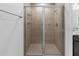 A stylish tiled walk-in shower featuring sleek glass doors and modern fixtures at 1416 Oak Marsh St, Davenport, FL 33837