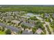 Aerial view of community with lake and dense trees at 14234 Desert Haven St # 14234, Windermere, FL 34786