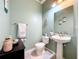 Charming half bath with a pedestal sink, unique decor, and a clean, well-maintained space at 14234 Desert Haven St # 14234, Windermere, FL 34786