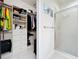 Clean and well-organized walk-in closet located next to a bathroom with a glass-enclosed shower at 14234 Desert Haven St # 14234, Windermere, FL 34786